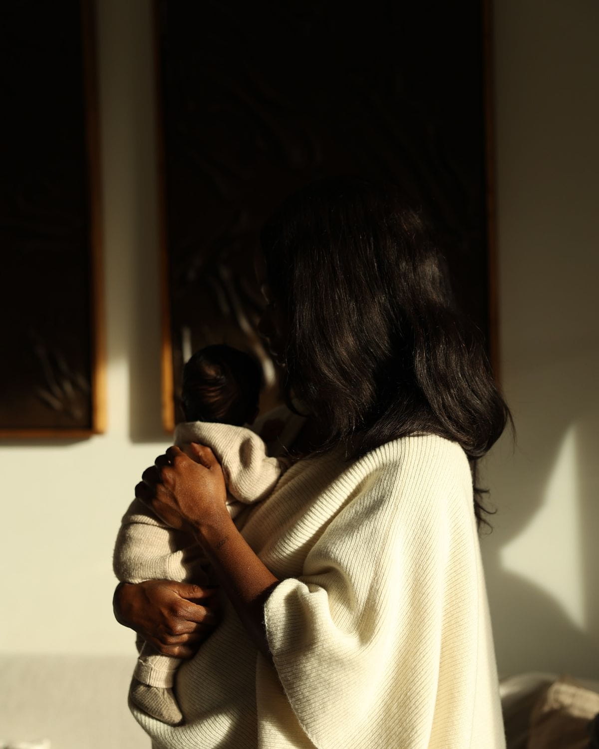 Newborn nursing, wrapped in soft cream linen